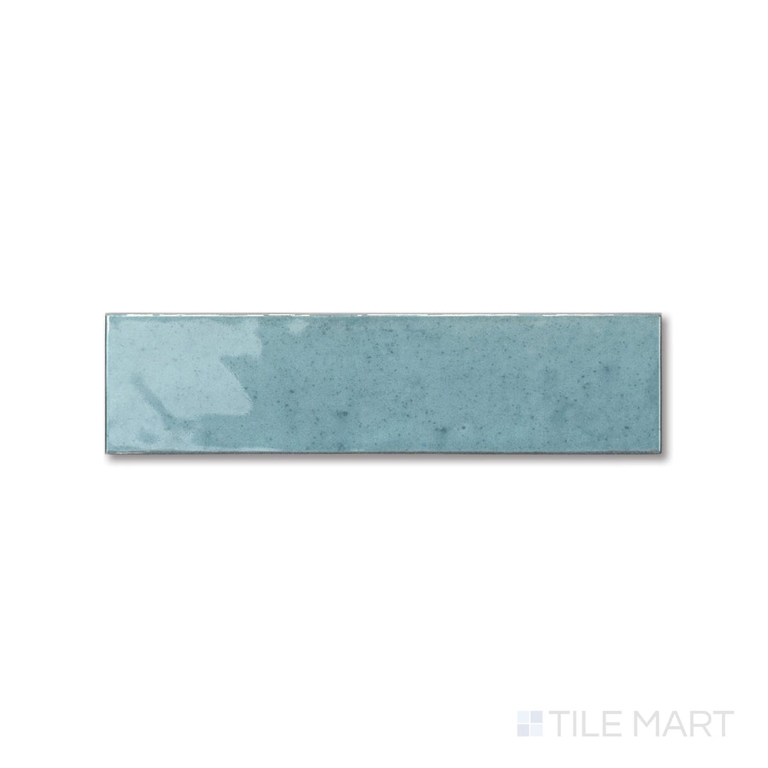 Top-down view of Agadir Agua 3x11 tile showing its bright aqua tone and smooth glossy surface in a narrow format.
