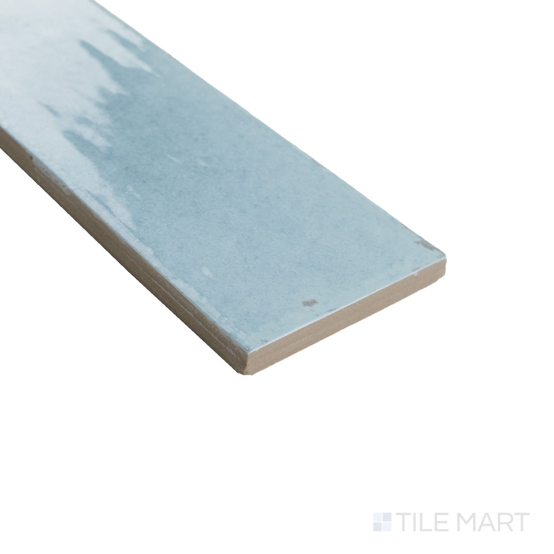 Corner shot of Agadir Agua 3x11 tile highlighting its bright aqua glaze and sleek edges in a slim, glossy format.