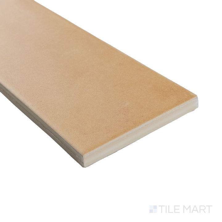 Angled view of Agadir Cotto Oscuro 3x11 matte tile showing earthy tones and a soft corner finish with a natural texture.