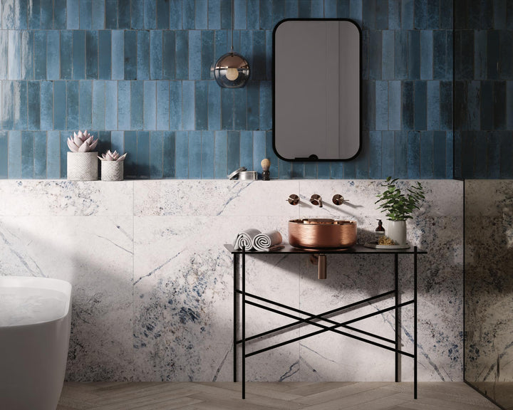 Agadir Lago 3x11 bright porcelain tile in cool blue tones, adding a sleek and glossy finish to vertical surfaces.