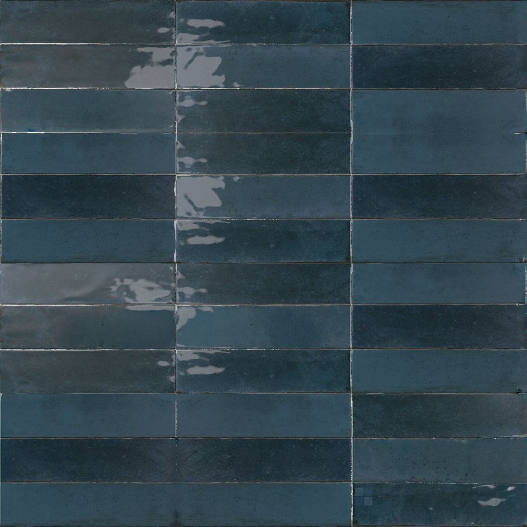 This 3x11 porcelain tile features a glossy lake-blue tone that adds vibrant depth to the Agadir Lago colorway.