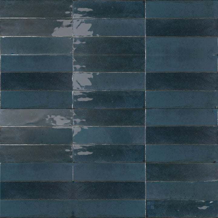 This 3x11 porcelain tile features a glossy lake-blue tone that adds vibrant depth to the Agadir Lago colorway.