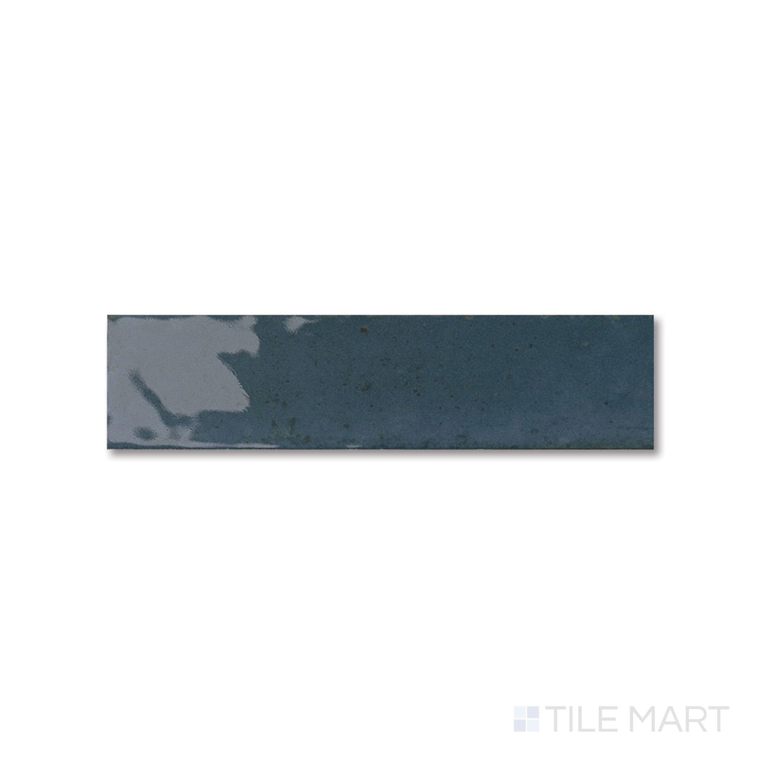 Flat lay of Agadir Lago tile with a deep blue glossy finish and slim 3x11 proportions.