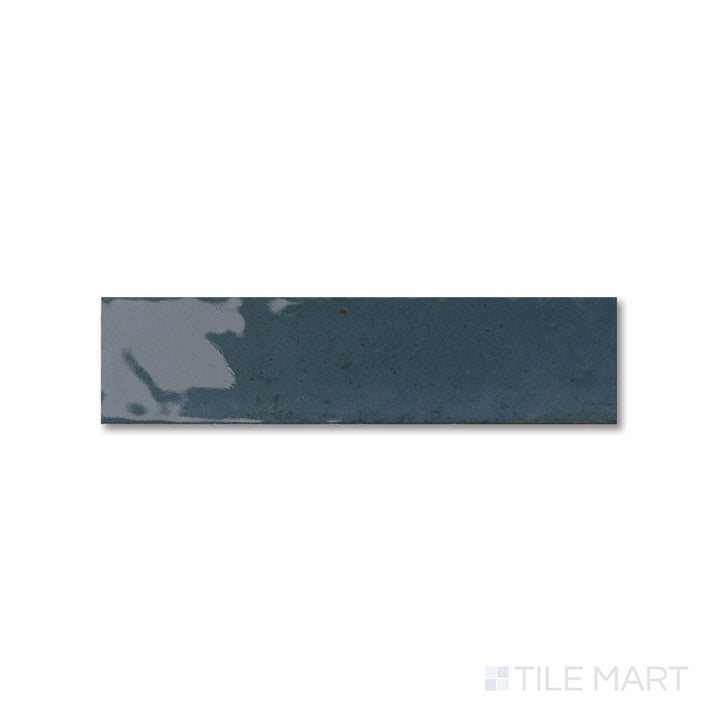 Flat lay of Agadir Lago tile with a deep blue glossy finish and slim 3x11 proportions.