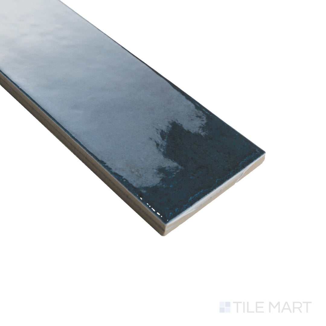 Corner detail of Agadir Lago 3x11 tile featuring a rich blue gloss and sharp edge that enhances its linear form.