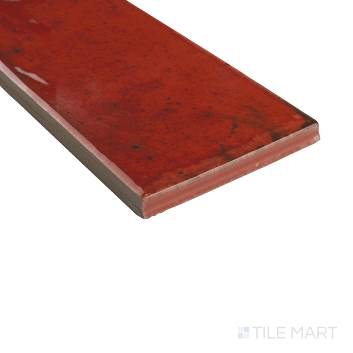 Close-up corner shot of Agadir Lava 3x11 tile with deep red gloss and crisp edge detailing.