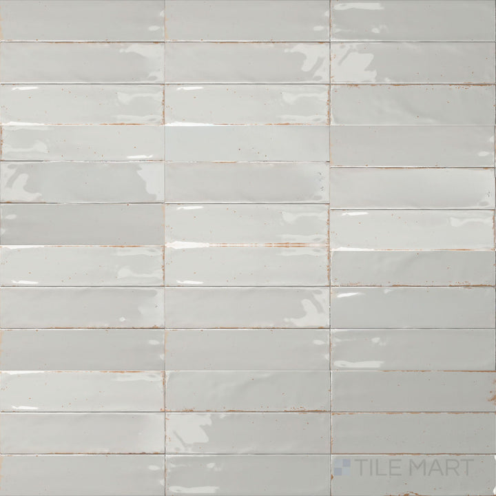 Soft misty gray with a glossy glaze gives this 3x11 Agadir Niebla porcelain tile a cool, atmospheric touch.