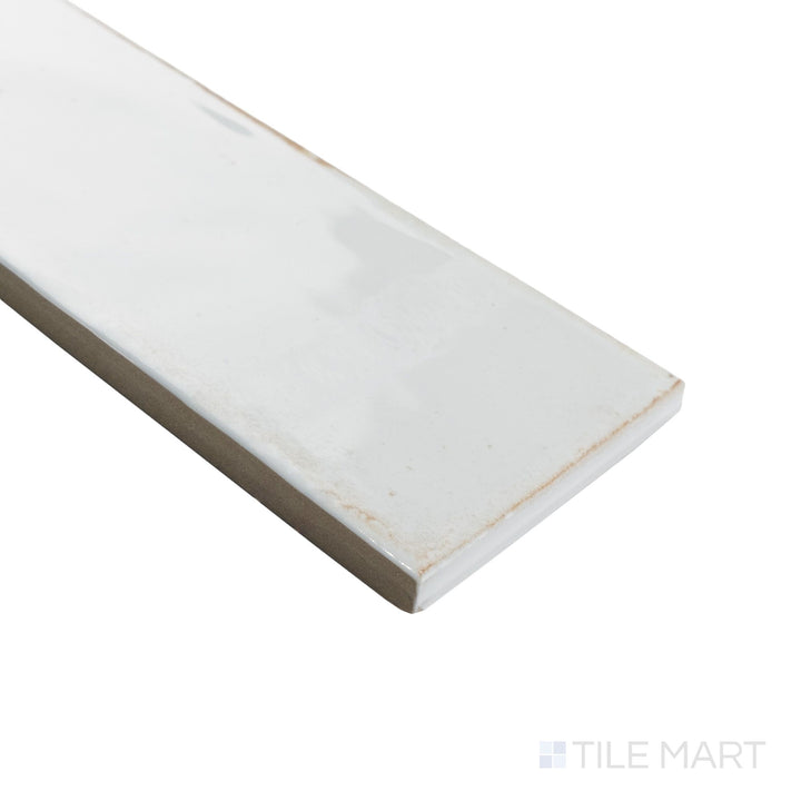 Corner perspective of Agadir Niebla 3x11 tile showing soft gray glossy surface with clean edge lines.