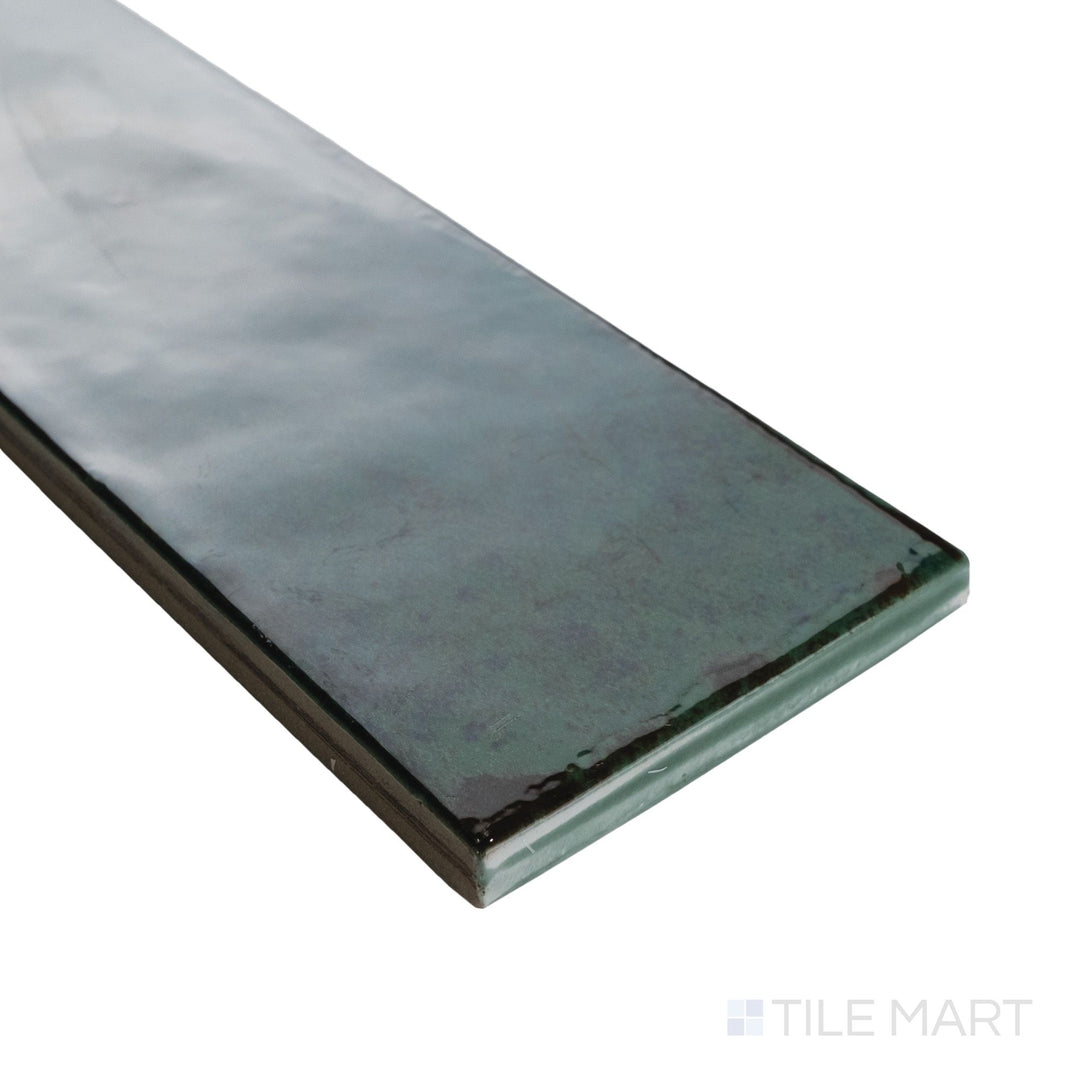 Corner shot of Agadir Selva 3x11 tile highlighting its vibrant green gloss and slim rectangular profile.