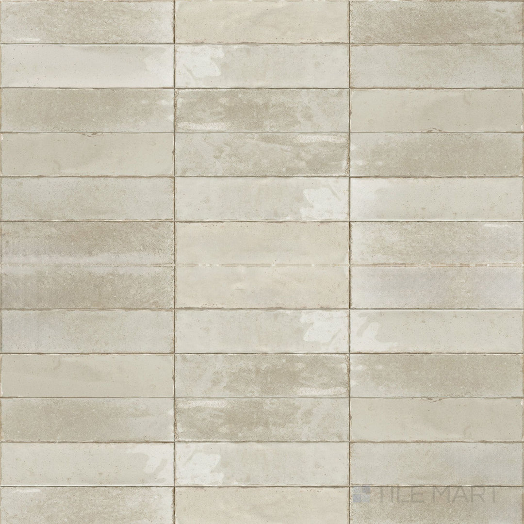 A soft ivory tone and glossy surface give this 3x11 Agadir tile a refined and luminous finish.