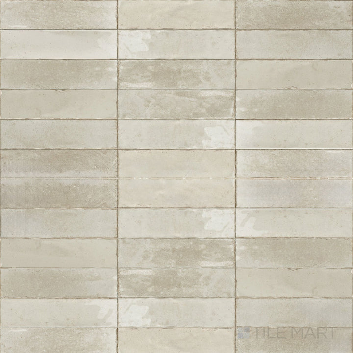 A soft ivory tone and glossy surface give this 3x11 Agadir tile a refined and luminous finish.