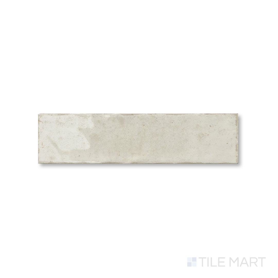 Top-down view of Agadir Ivory 3x11 tile showing its soft cream tone and smooth glossy finish in a narrow layout.