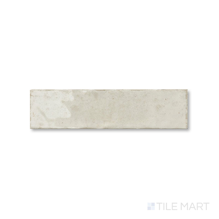 Top-down view of Agadir Ivory 3x11 tile showing its soft cream tone and smooth glossy finish in a narrow layout.