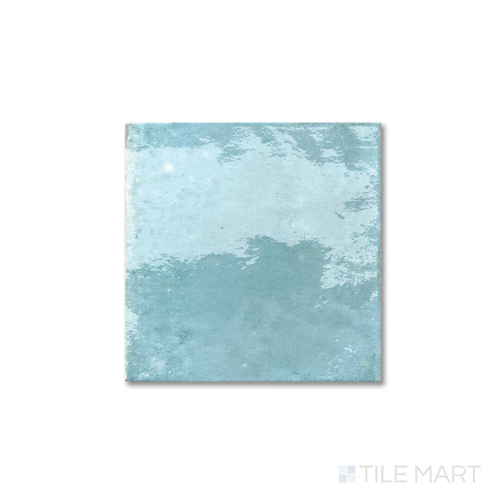 Flat lay of Agadir Agua 6x6 tile featuring a bright aqua glaze and polished porcelain surface.