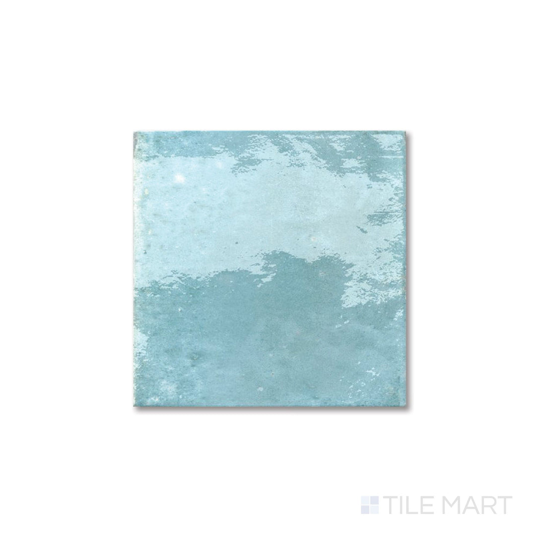 Flat lay of Agadir Agua 6x6 tile featuring a bright aqua glaze and polished porcelain surface.