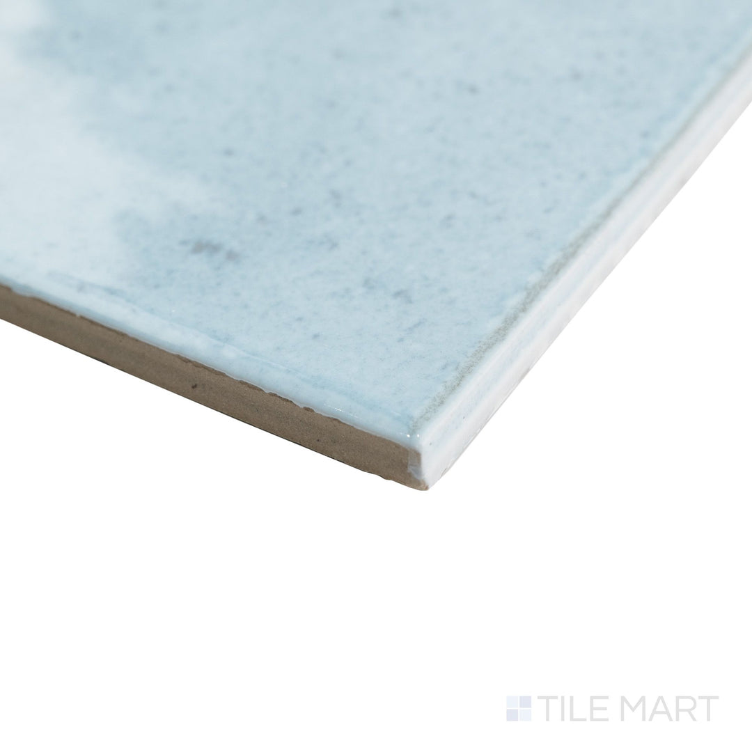 Corner view of Agadir Agua 6x6 tile capturing bright aqua tones and a glossy surface wrapping smoothly around a square edge.