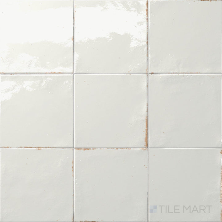 Cool gray tones with a reflective glaze create a misty aesthetic in this 6x6 Agadir Niebla tile.