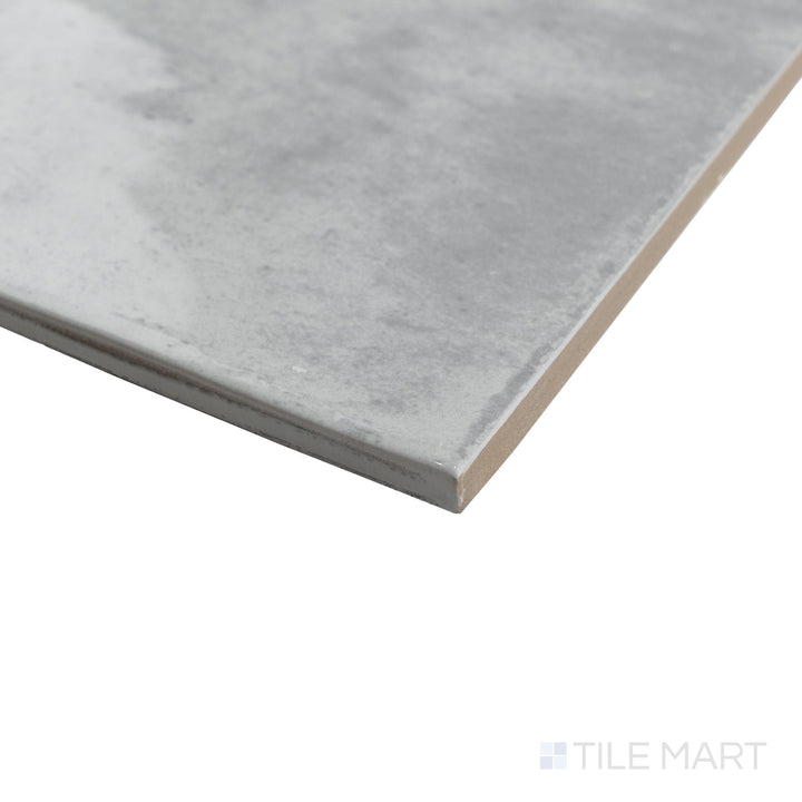 Close-up corner shot of Agadir Piedra 6x6 tile with natural stone-inspired tones and a polished edge transition.