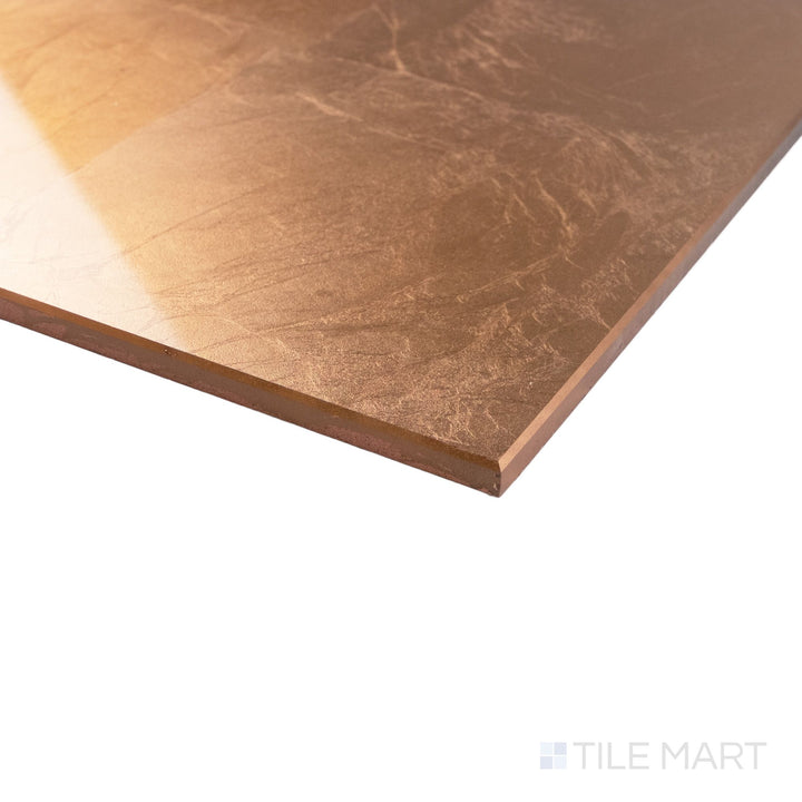 Angled view of Cristal Foglio Di Rame 10x30 glass tile featuring metallic copper shine and clean-cut corner edge.