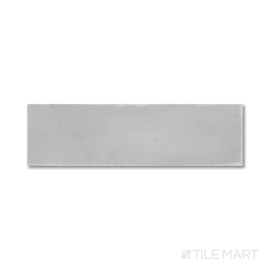 Top-down view of Milano Grigio 3x9 tile with a soft gray matte surface and clean, modern lines.