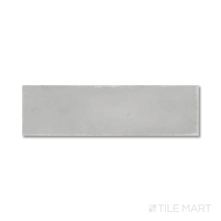 Top-down view of Milano Grigio 3x9 tile with a soft gray matte surface and clean, modern lines.