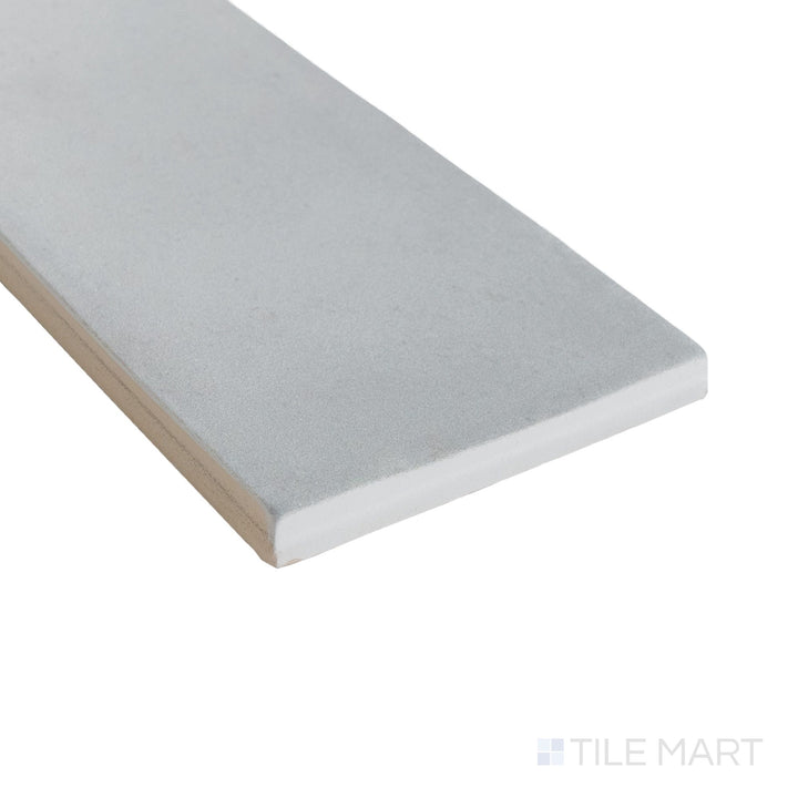 Angled view of Milano Grigio 3x9 tile featuring a cool gray matte surface and sharp linear edge.