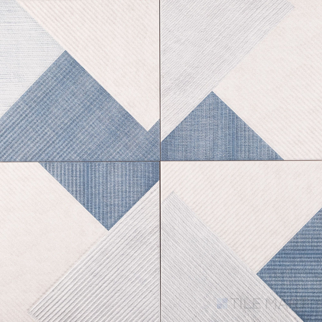 Denim blue tones and fine striping create a relaxed, fabric-inspired look in this 10x10 matte tile.