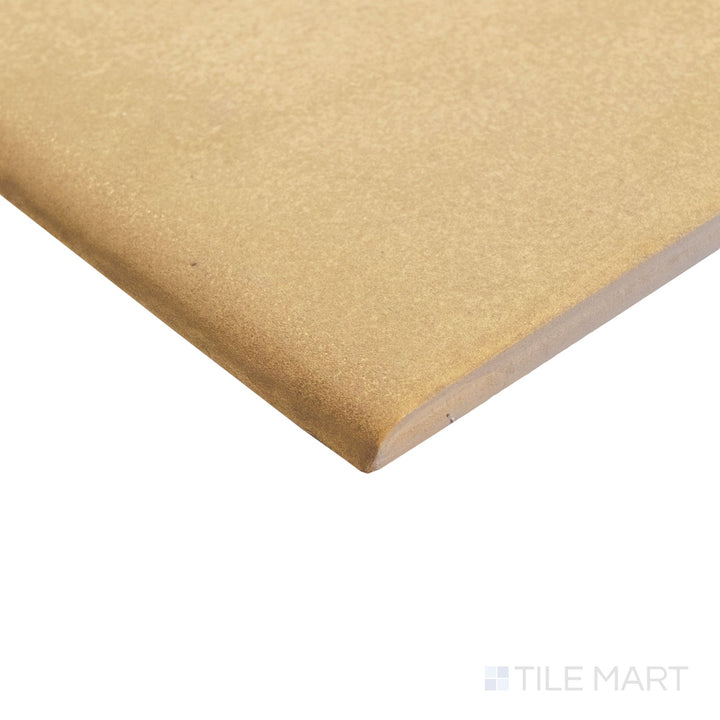 Close-up corner of Golden Stone 6x6 matte porcelain bullnose, highlighting the rounded edge and soft finish transition.