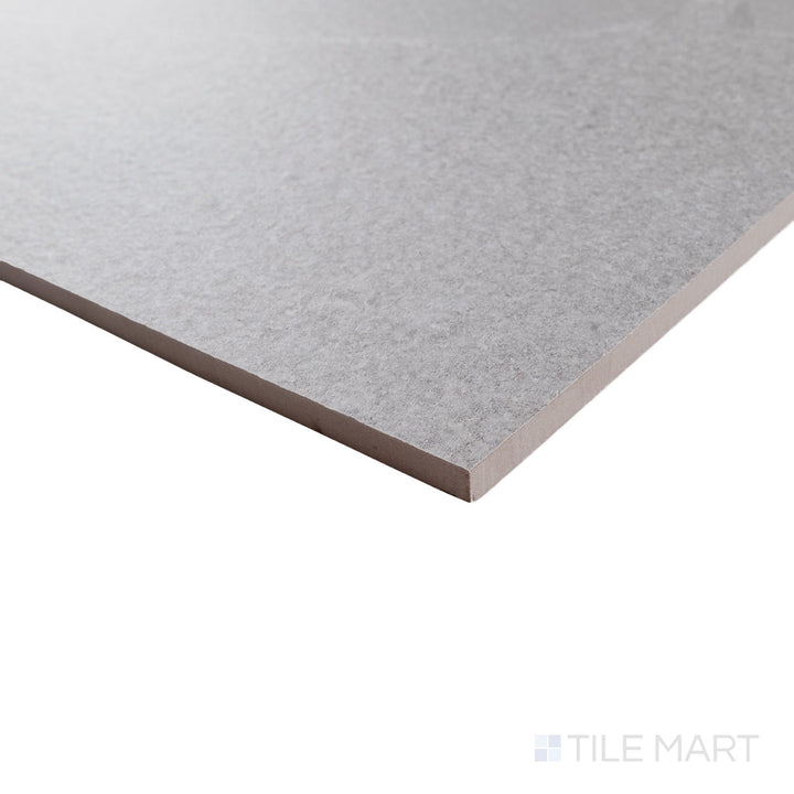 Angled corner view of Pietrasanta Light Grey Anti-Slip 35x35 tile showing textured matte finish and subtle stone detail.