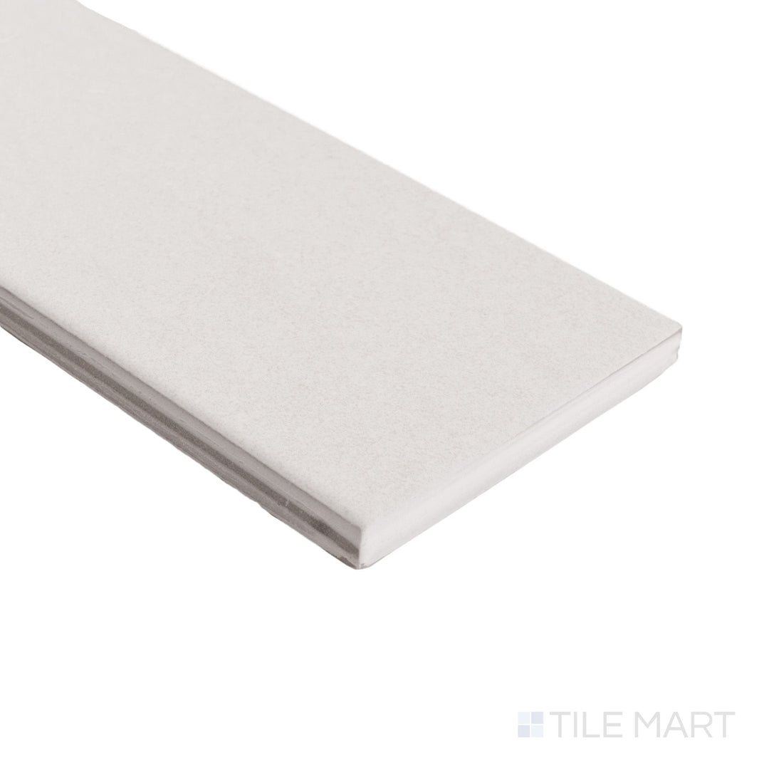 Close-up angled view of Pietrasanta Ivory 3x11 matte tile with subtle veining and clean corner edge.