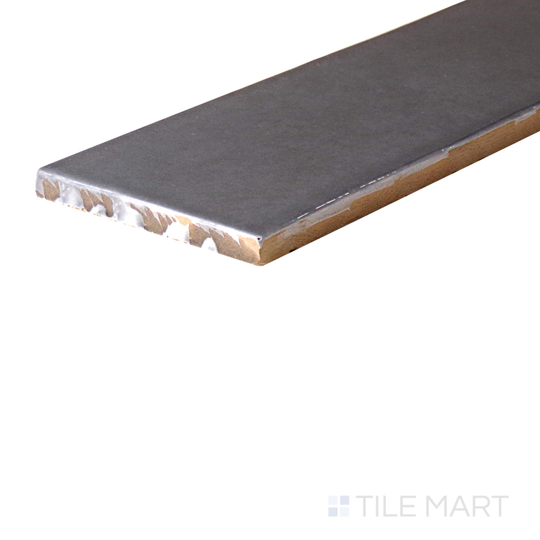 An angled look at the CARBON HIGHLAND LAKE tile, highlighting its smooth glaze and the boldness of its deep shade.