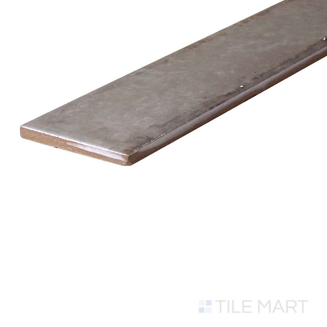 An angled look at the ASHEN ORGANIC CLAY tile, highlighting its reflective sheen and the boldness of its deep shade.