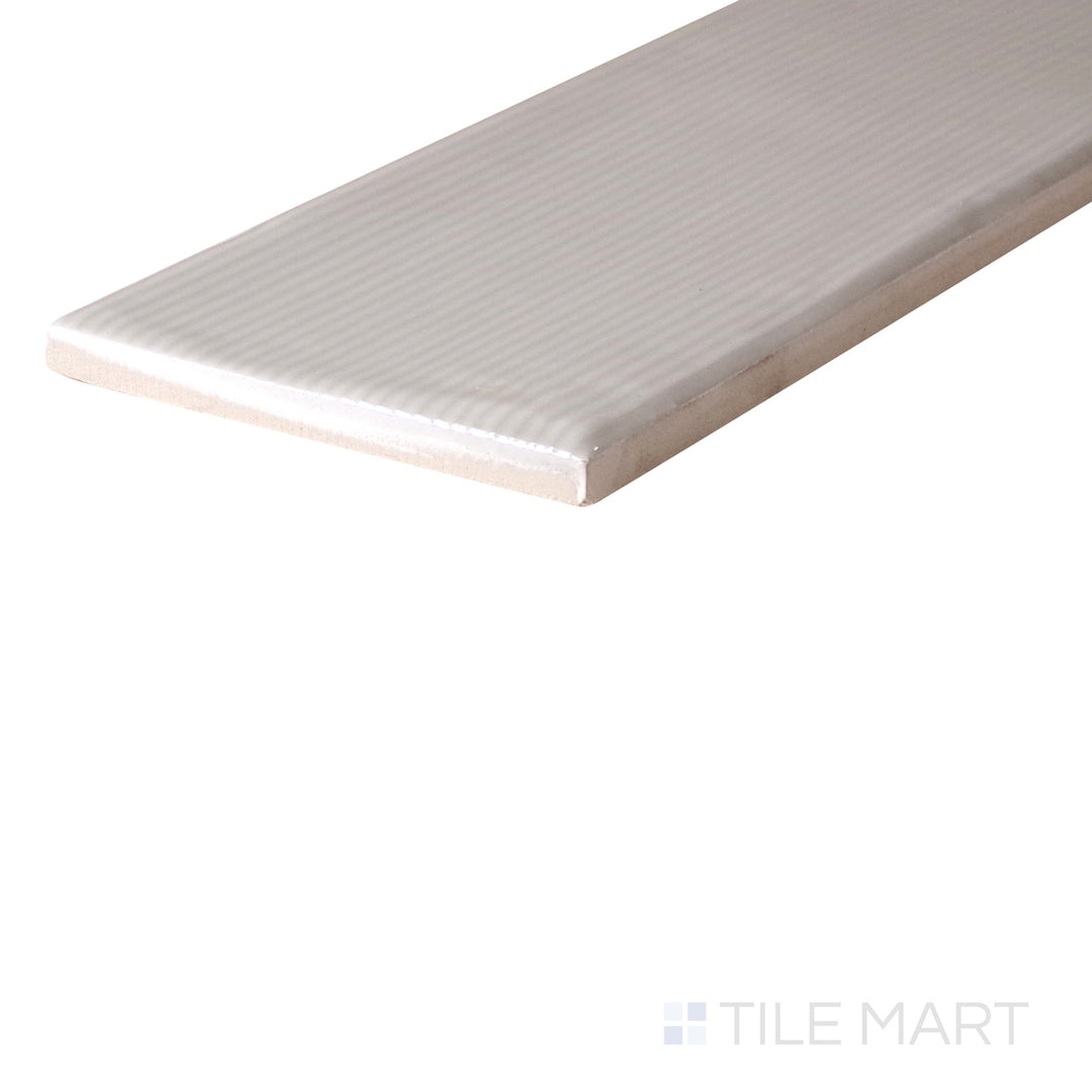 An angled look at the GREIGE ZEN tile, highlighting its glossy finish and the boldness of its deep shade.