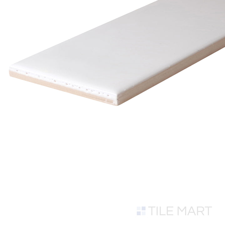 An angled look at the WHITE ZEN tile, highlighting its reflective sheen and the boldness of its warm hue.