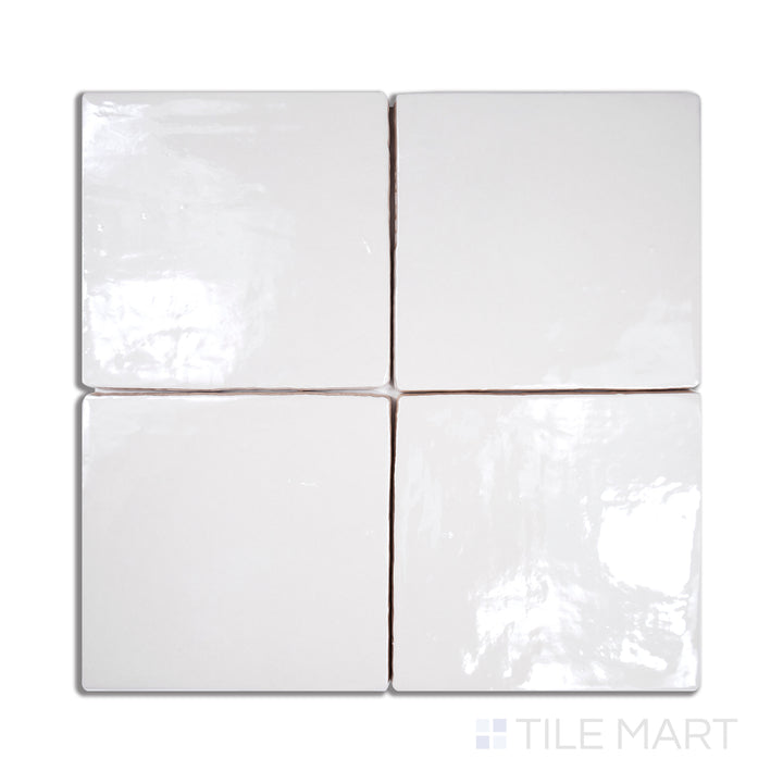 An angled look at the vintage white tile, highlighting its glossy finish and the boldness of its warm hue.