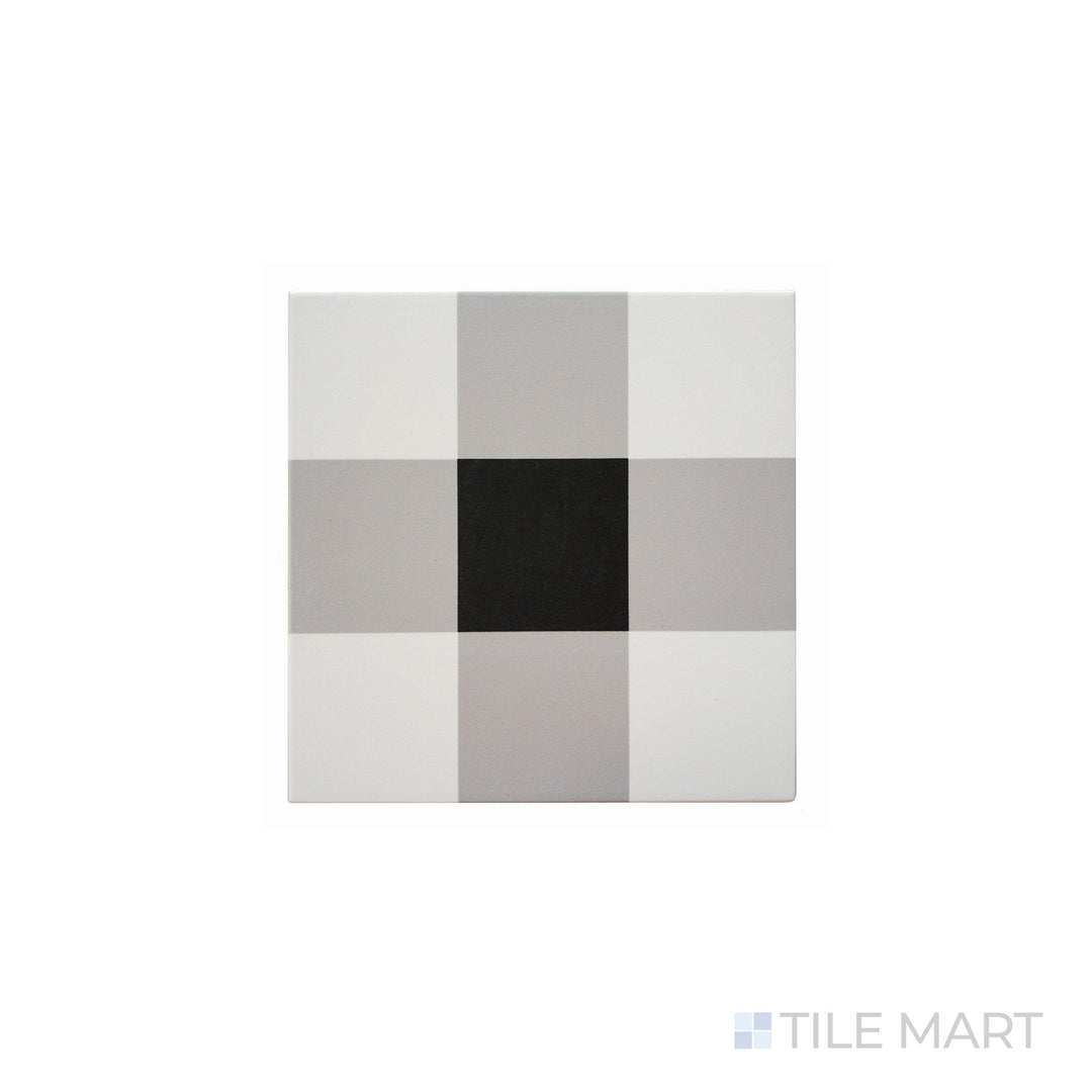 An angled look at the plaid white & black studio tile, highlighting its textured coating and the boldness of its warm hue.