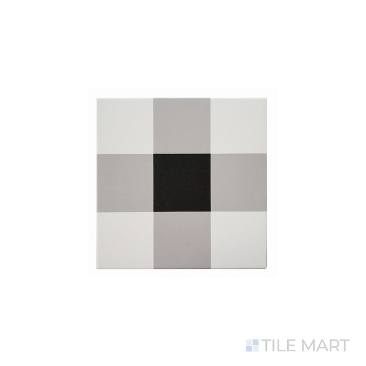 An angled look at the plaid white & black studio tile, highlighting its textured coating and the boldness of its warm hue.