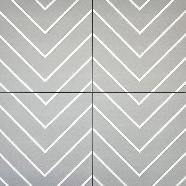 Bird's eye view showcasing the grey with white studio tile, sized 8x8, with a textured coating that enhances its warm hue.