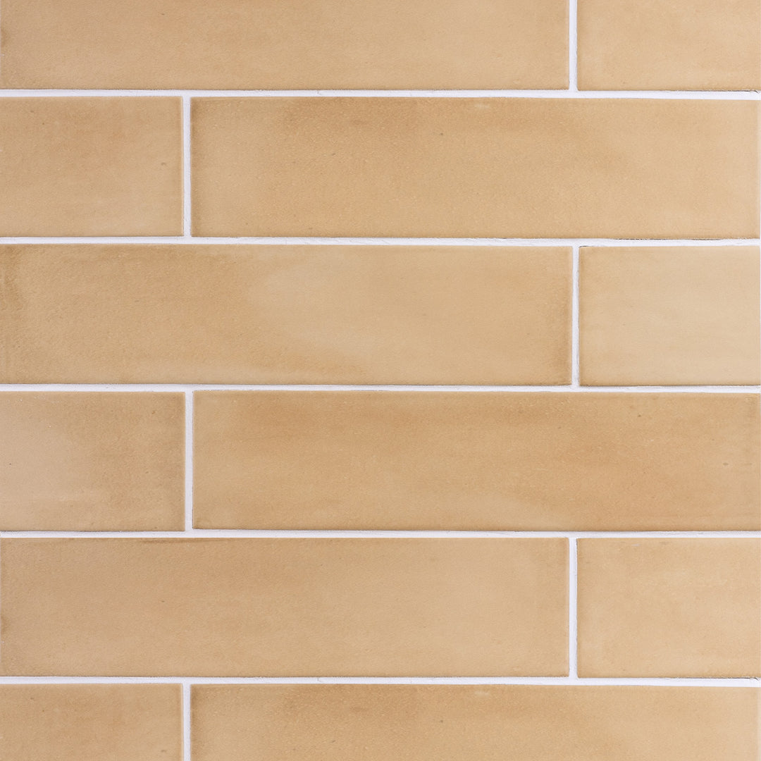 Top angle showcasing the rectangle sand clay tile, sized 2.5x10, with a matte surface that enhances its deep shade.