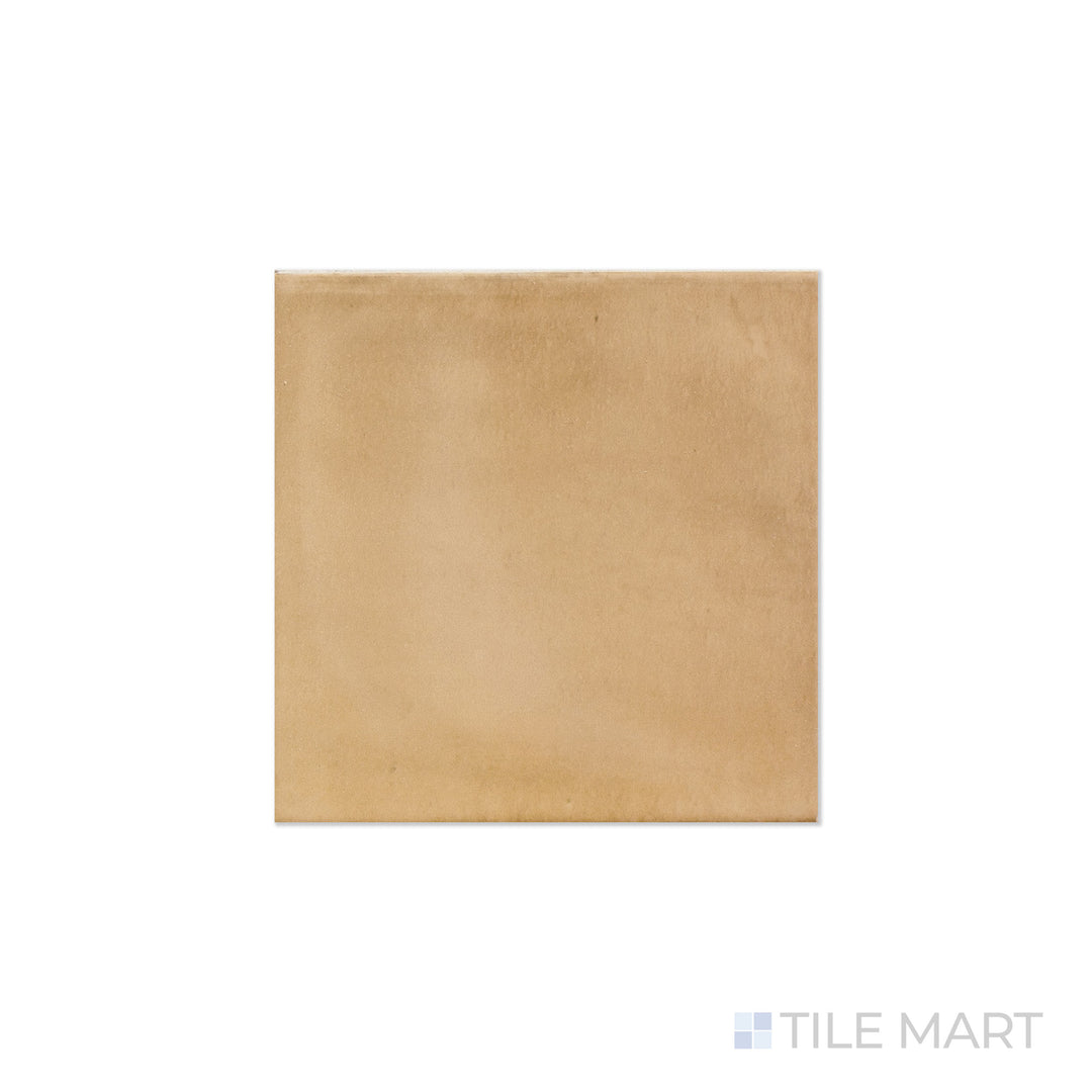 An angled look at the square sand clay tile, highlighting its matte surface and the boldness of its deep shade.
