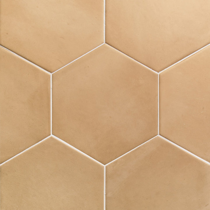 Flat perspective showcasing the hex sand clay tile, sized 7x8, with a reflective sheen that enhances its soft undertone.