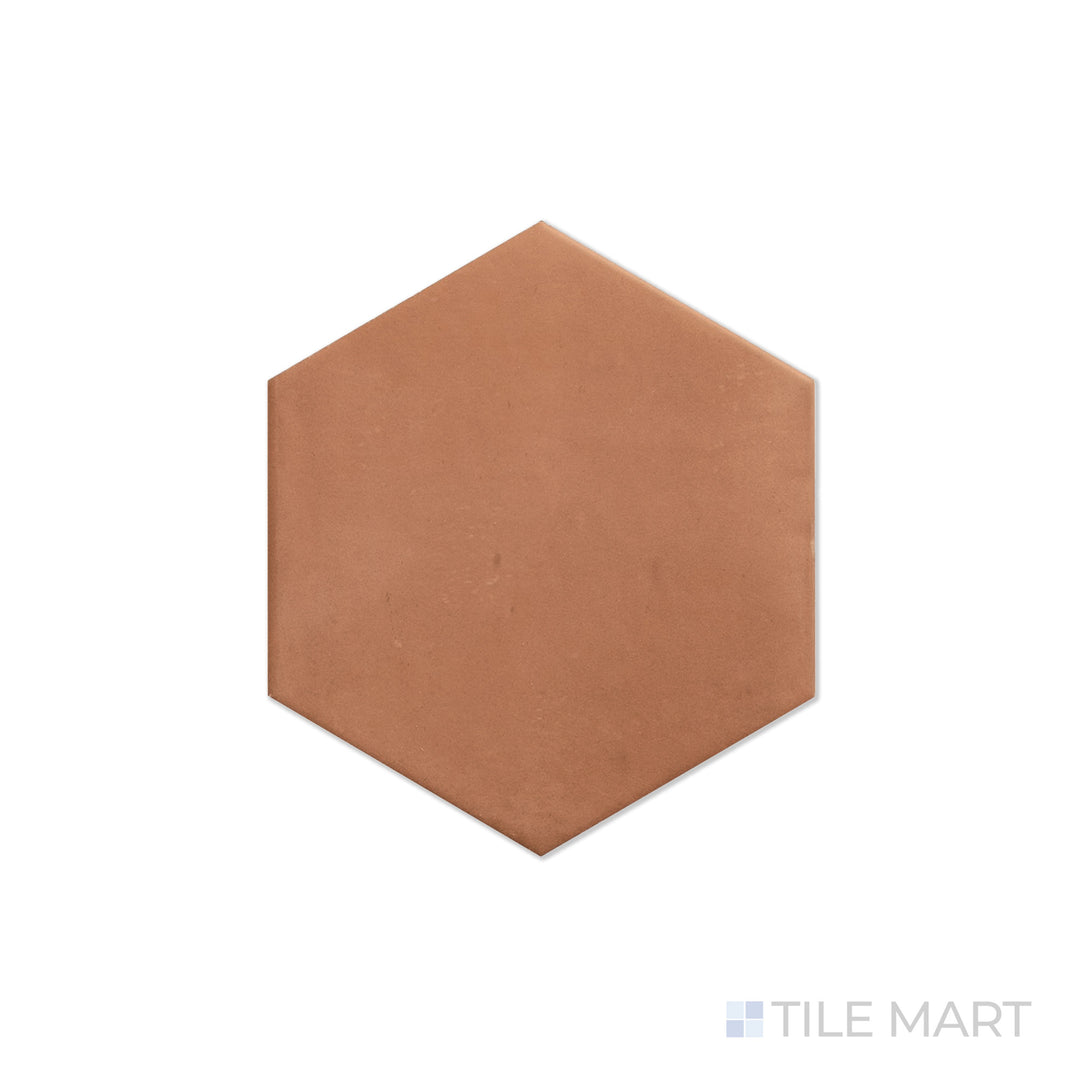 An angled look at the hex brick clay tile, highlighting its glossy finish and the boldness of its warm hue.