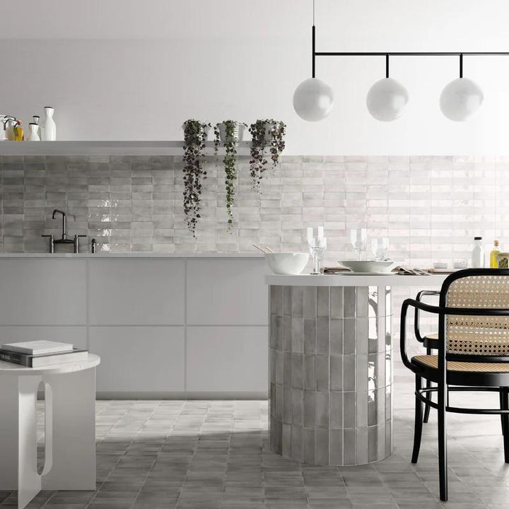 Cool grey tones and a glossy finish create a polished and contemporary feel with Soco Grey 2x6 porcelain tile.