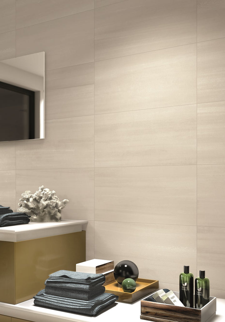 Warm ivory tones and a matte finish bring a timeless and soft aesthetic to Flow Ivory 12x24 porcelain tile.