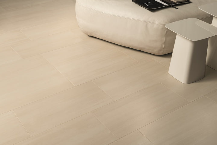 A room scene, featuring beige flow tile with a matte texture, bringing a sleek look to the room.