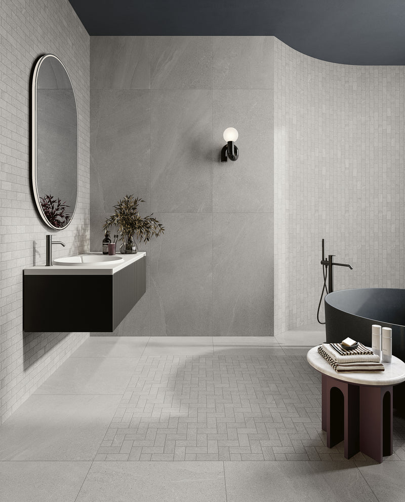 Boston Gray 12X24 matte porcelain tile offers a sleek and versatile look, blending seamlessly into contemporary spaces.