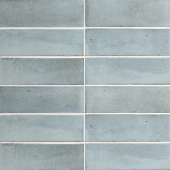 Top-down view of Soco Light Blue 2x6 inch matte porcelain tile, featuring a soft pastel blue tone with a smooth, non-reflective finish.
