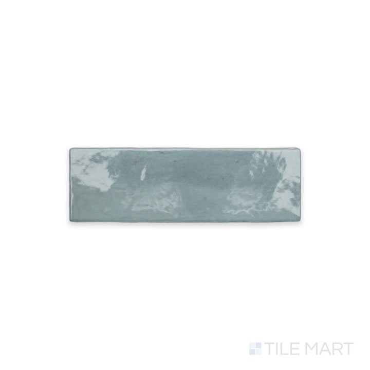 A detailed view of Soco Light Blue 2X6 Glossy Porcelain, showcasing its airy blue tone and polished surface for enhanced light reflection.