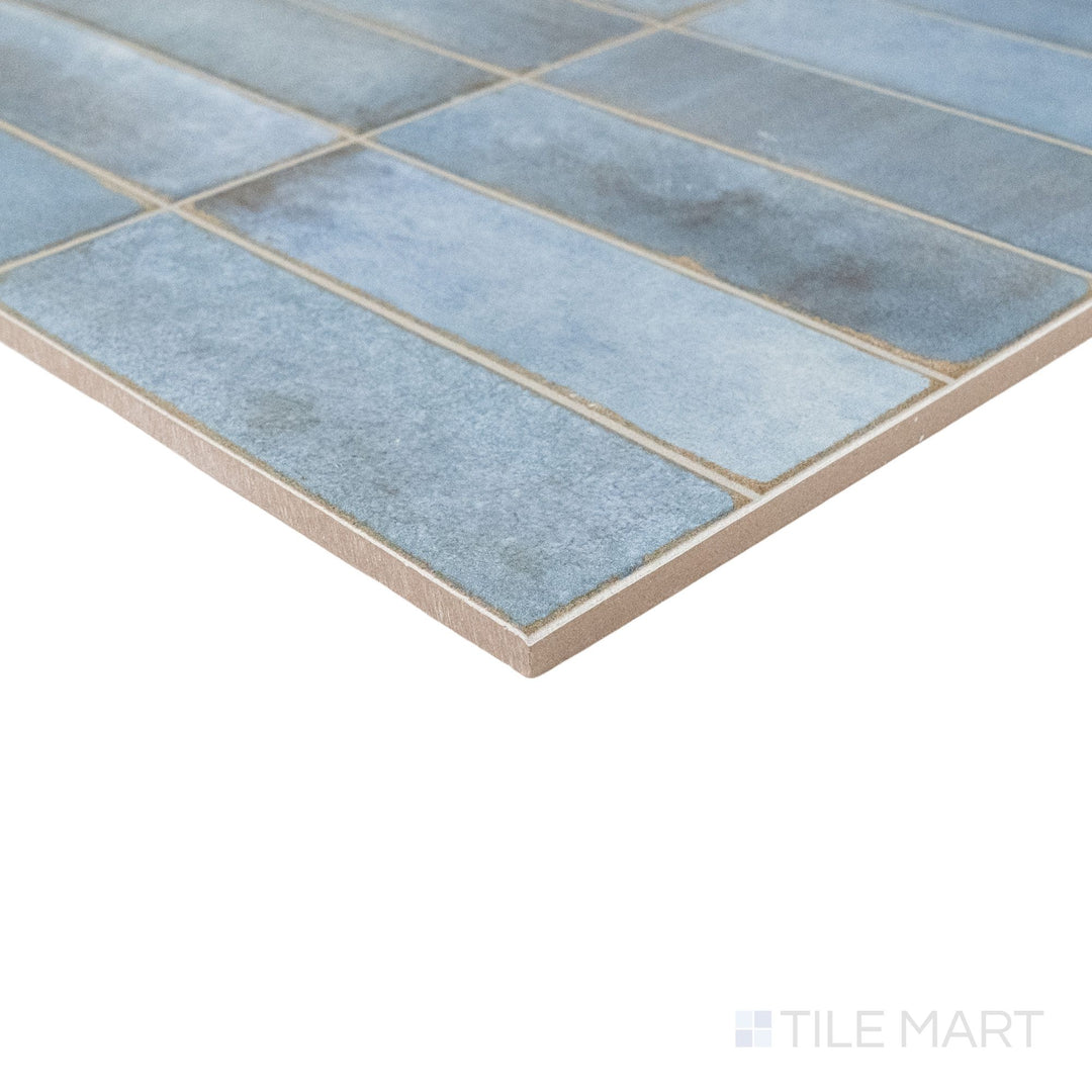 Corner shot of Decoris Artis Light Blue tile revealing its edge profile and reflective glossy glaze.