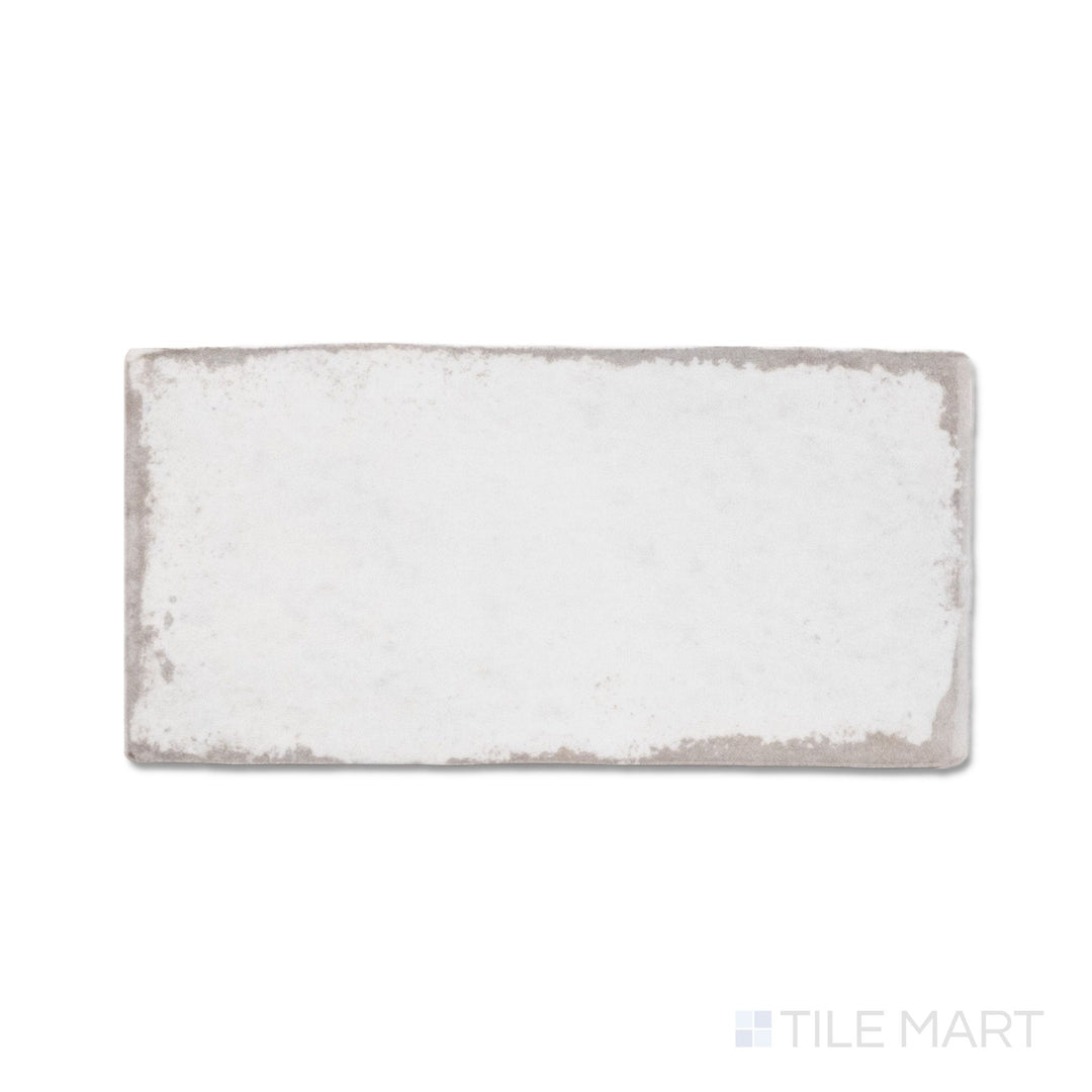 Top-down view of a single Retrospectives Enchanted Mist 3x6 glossy ceramic subway tile showing its soft enchanted mist surface and light-reflective glossy finish detail